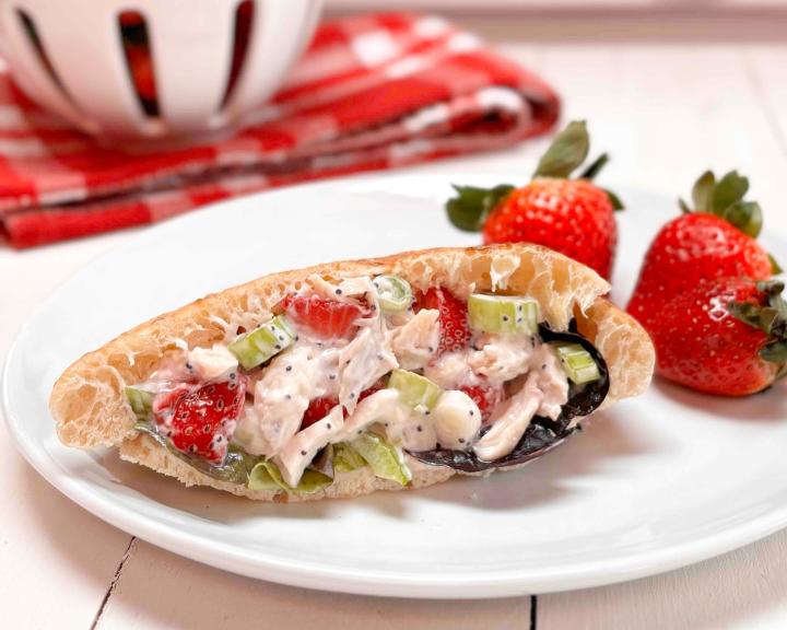A sandwich with strawberry chicken salad filling on a plate. 