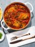 A bowl of several braised Moroccan chicken breasts