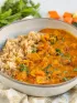 A bowl of richly spiced Indian butter chicken served with brown rice for a health Indian diet