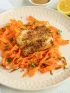 Lemon herb crusted fish with carrot ribbons on plate