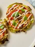 two cabbage pizzas on a plate with ranch style dressing