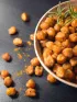 Roasted chickpeas in a bowl on a dark table.