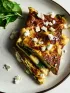 Spinach and feta omelet with fresh spinach on a white plate.