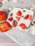 Frozen yogurt bark with strawberries, chocolate chips, and fresh mint.