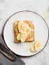Peanut butter and banana toast on a white plate.