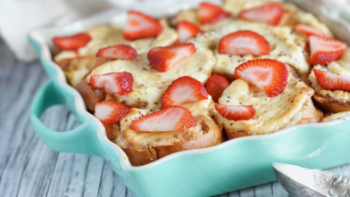 A blue casserole dish with strawberry french toast casserole