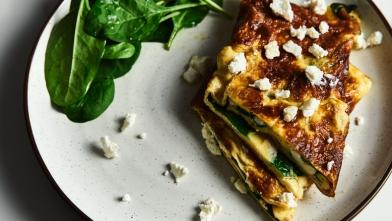 An omlete with spinach on a plate