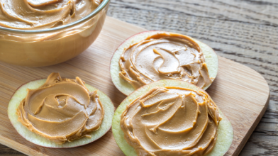 Apple slices with peanut butter spread on them