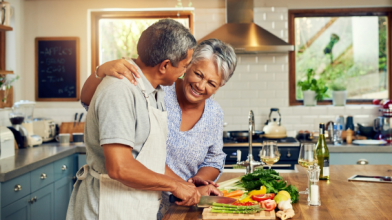 A Latinx couple cooking in the kitchen together