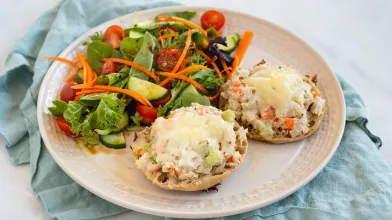 Tuna salad melt served with a salad on a plate