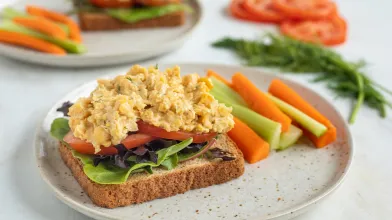 An open face vegan vegetarian sandwhich with chickpea and carrots and celery on a plate for diabetes friendly diet