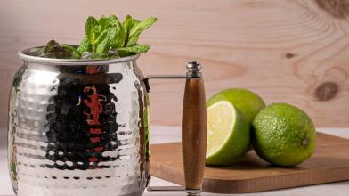 A diabetes friendly Moscow mule mocktail in a metal cup with limes