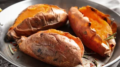 Three baked sweet potatoes in a dish