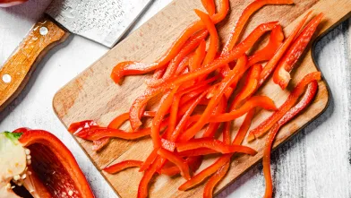 sliced red bell peppers on wooden cutting board