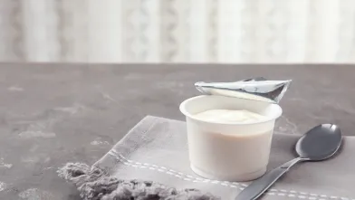 a container of soymilk yogurt on a napkin