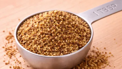 1 tablespoon of ground flaxseed in stainless steel measuring spoon