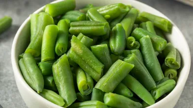 small white bowl containing steamed green beans