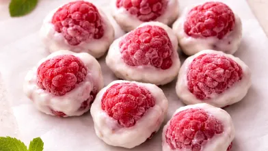 Gluten-free frozen raspberry yogurt clusters on parchment paper