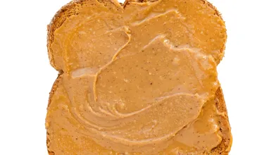 Slice of toast with peanut butter spread.