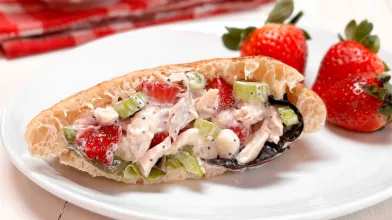 A sandwich with strawberry chicken salad filling on a plate. 