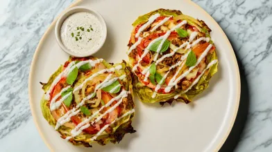 two cabbage pizzas on a plate with ranch style dressing