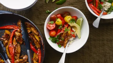 Chicken fajita bowl with cauliflower rice, cherry tomatoes, and avocado slices