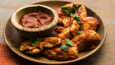 Lean chicken tenders coated in BBQ sauce, served with a dipping sauce.