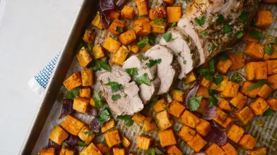 Sheet pan meal: sliced pork tenderloin, roasted sweet potatoes, and red onions.