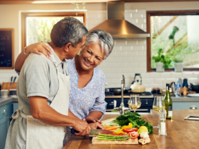 A Latinx couple cooking in the kitchen together