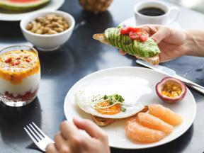 Healthy breakfast with avocado toast and fruit