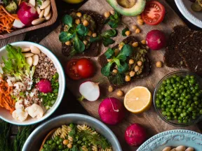 overhead shot of vegetables and salads on wood plank