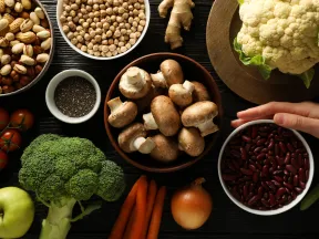 Various vegetables and nuts on a table.