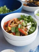 Chicken, black bean, red and green pepper bowl with cilantro, onion.