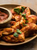 Lean chicken tenders coated in BBQ sauce, served with a dipping sauce.