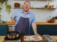 Smiling chef giving online cooking class