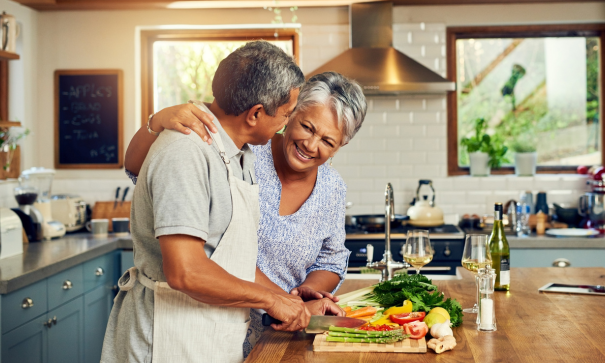 A Latinx couple cooking in the kitchen together