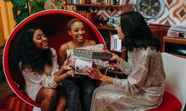 A group of women exchanging diabetes-friendly holiday gifts for food lovers