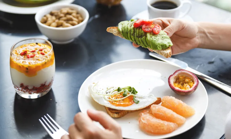 Healthy breakfast with avocado toast and fruit