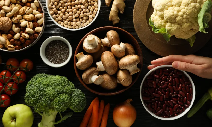 Various vegetables and nuts on a table.