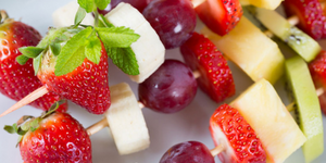 A kebab of strawberries, grapes, and cheese