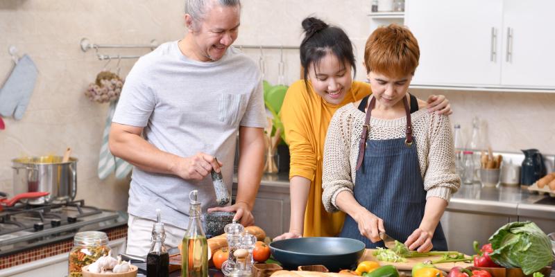 Family preparing meal together in kitchen