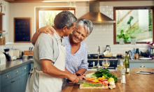 A Latinx couple cooking in the kitchen together