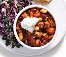 A bowl of easy beef chili and dollop of sour cream