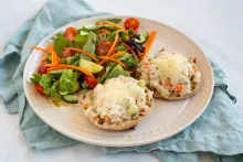 Tuna salad melt served with a salad on a plate