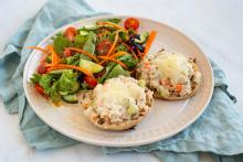 Tuna salad melt served with a salad on a plate