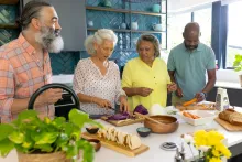 A group of people creating healthy cultural foods for a diabetes friendly meal to share