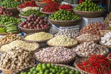 A variety of baskets filled with herbs and veggies from around the world for make global diabetes friendly recipes