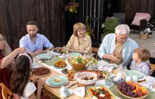 Multi-generational family eating healthy meal at picnic table