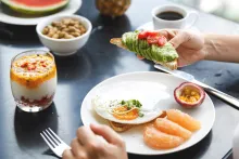 Healthy breakfast with avocado toast and fruit