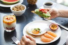 Healthy breakfast with avocado toast and fruit